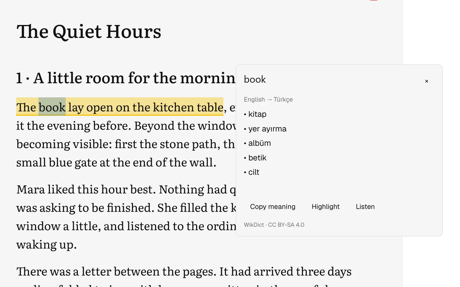 An English → Turkish dictionary card open over the word “book” in a highlighted sentence